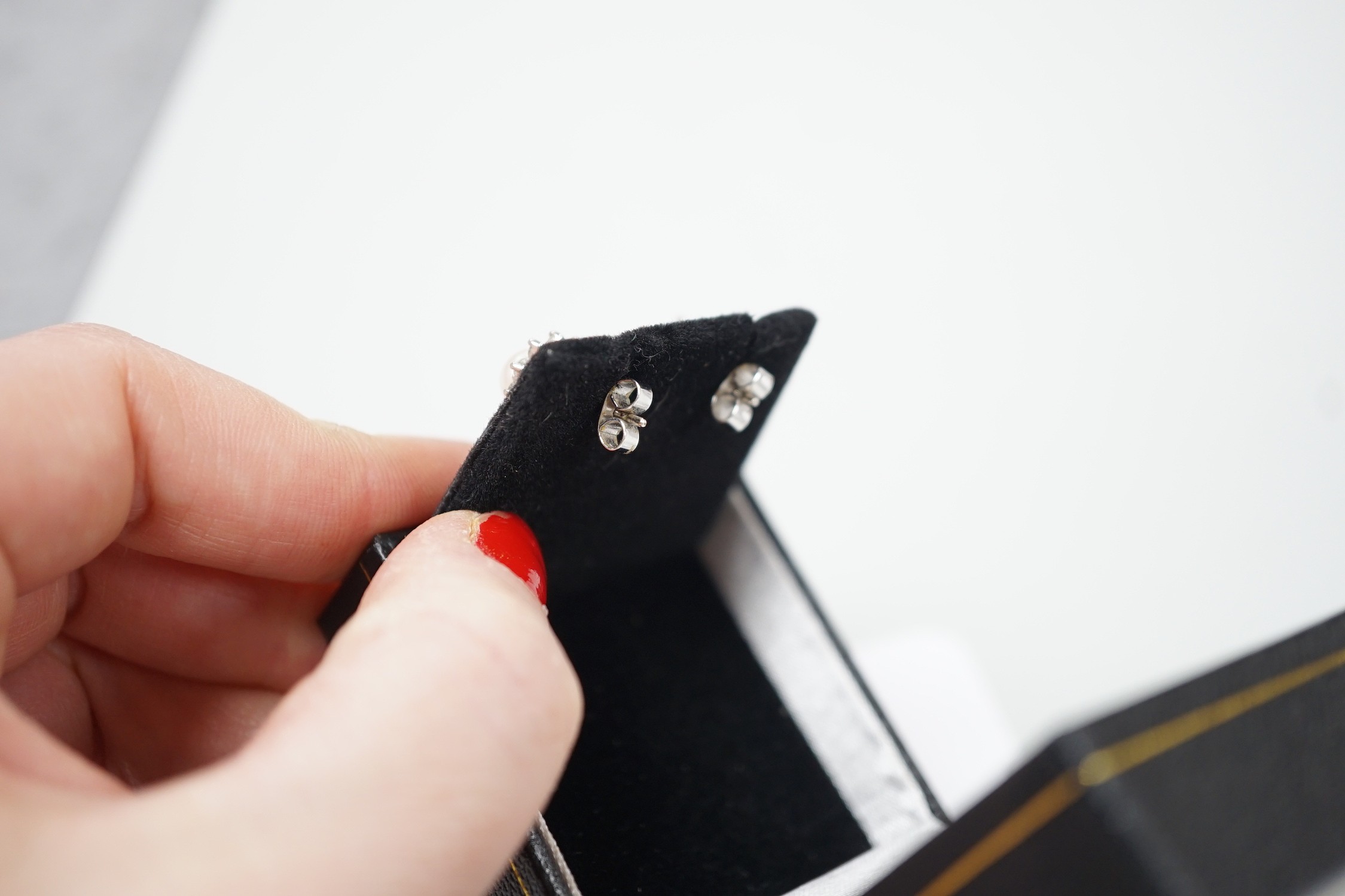 A modern pair of 18ct white gold, cultured pearl and diamond cluster set ear studs, 11mm, gross weight 3 grams.